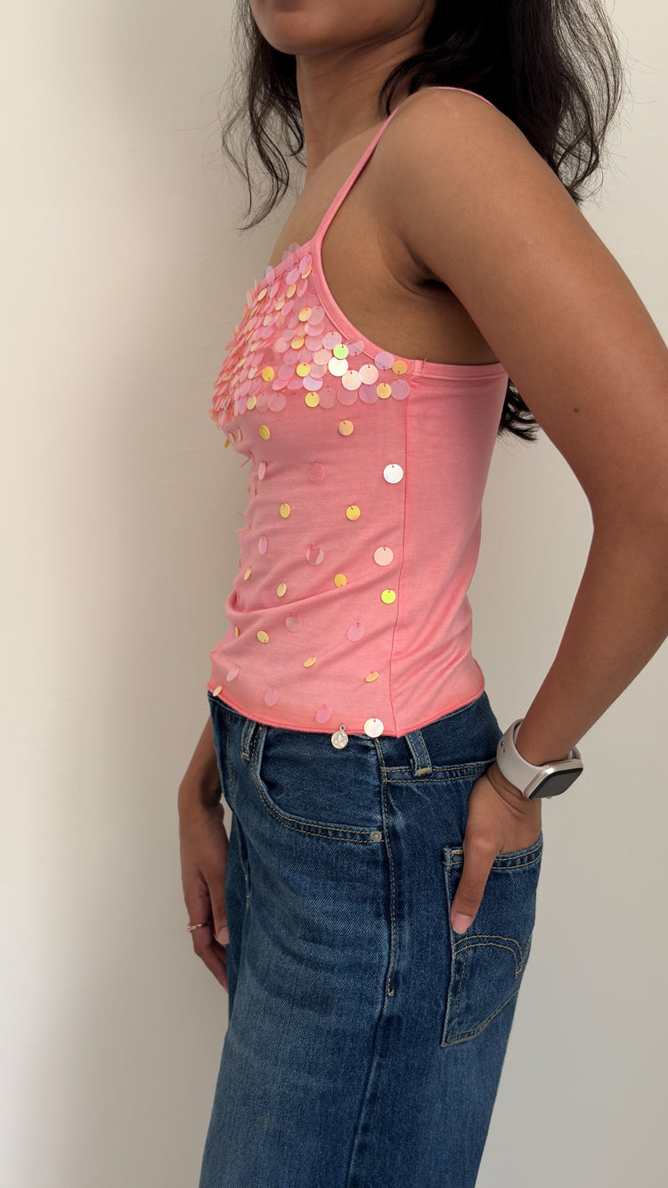 Model wearing peach sequinned camisole, side profile
