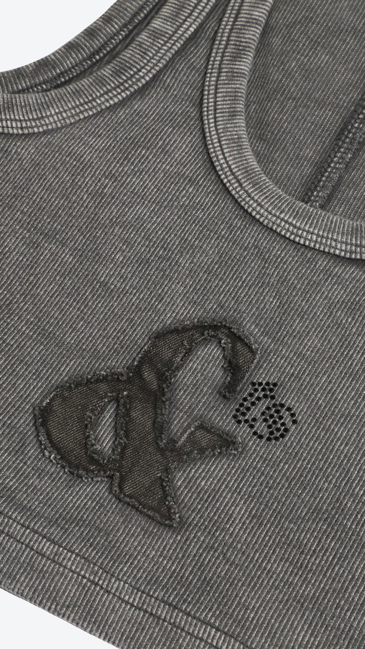 Close-up of a dark gray garment with a logo on a white background