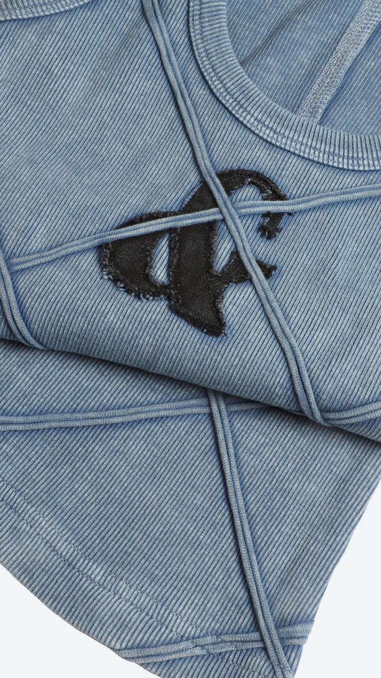 Close-up of a blue denim tank top with a black logo on a white background