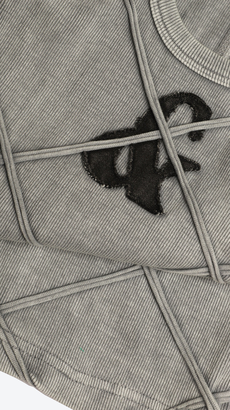 Detailed shot of a gray tank top with a black logo on a white background