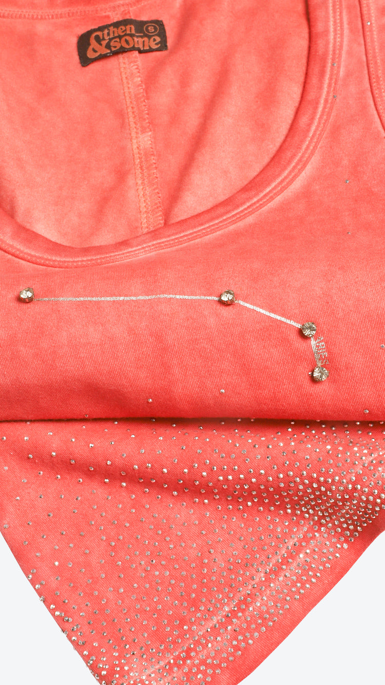 Close-up of a shell pink garment with rhinestone embellishments.