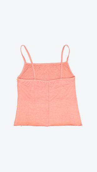 Back of a peach-coloured camisole top with thin straps on a white background