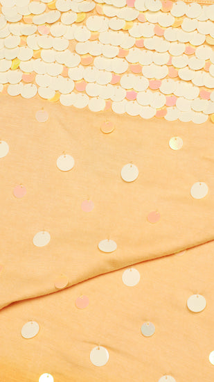 Detailed shot of an orange sequinned camisole