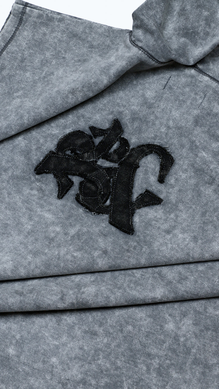 Gray fabric with black logo patch on a white background