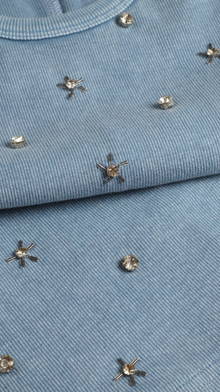 Close-up of a blue tank top with decorative studs 