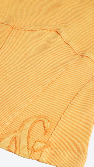 Close-up of an orange fabric with a brand logo on a white background