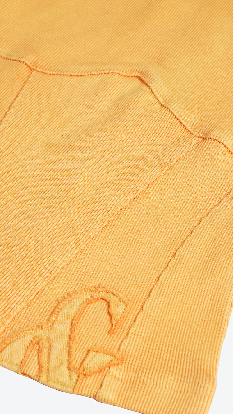 Close-up of an orange fabric with a brand logo on a white background