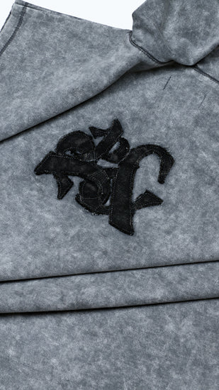 Gray fabric with black logo patch on a white background